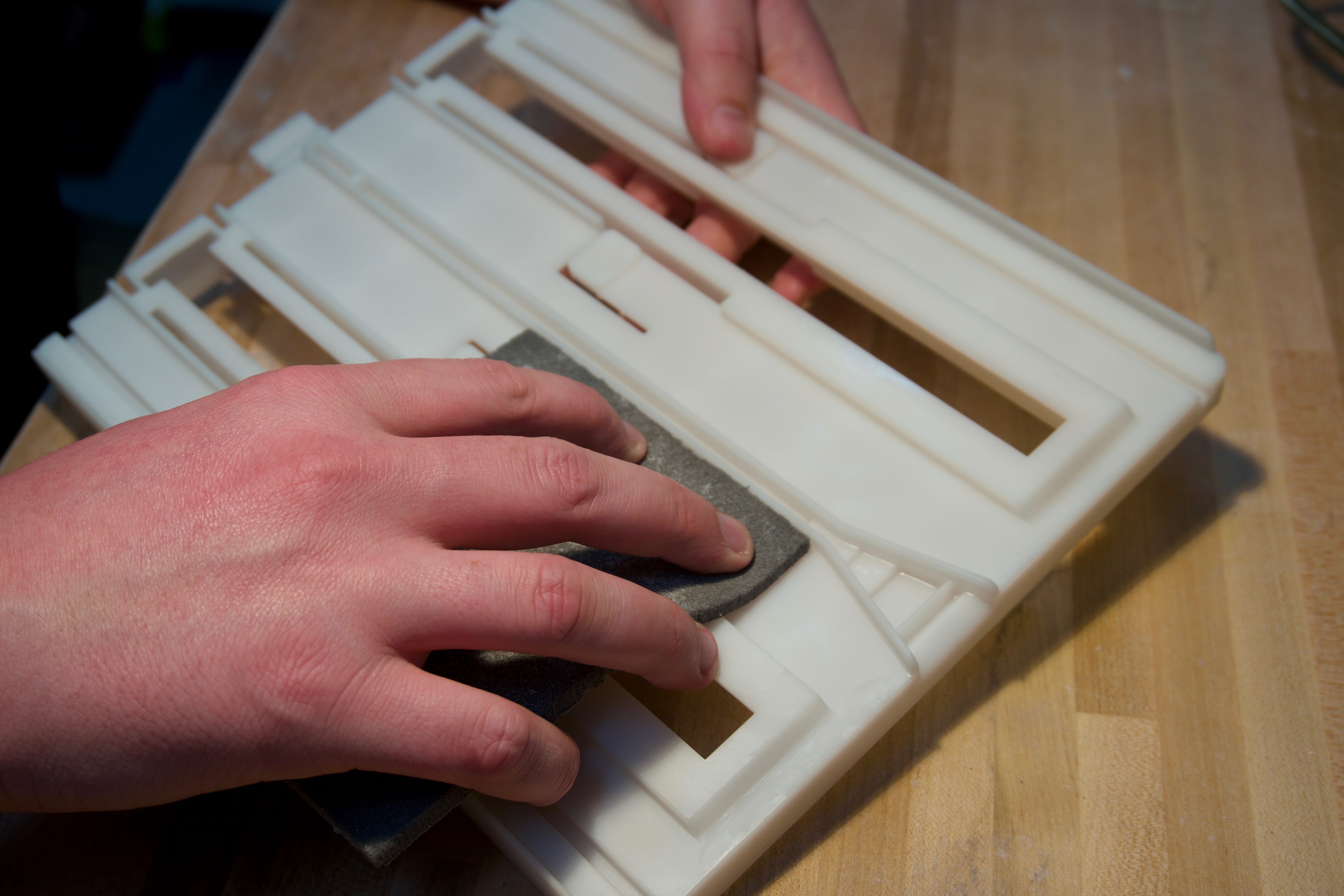 Model Making and 3D Printed Part Finishing - hand sanding a Somos NeXt Tray